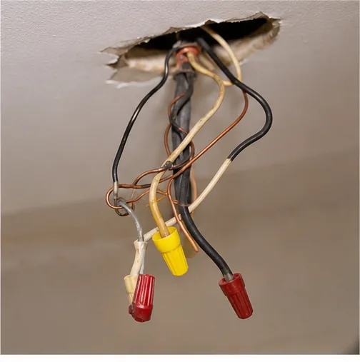 Exposed ceiling junction box with capped wiring connections