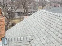 Missing shingles exposing the deck on a Hutchinson roof